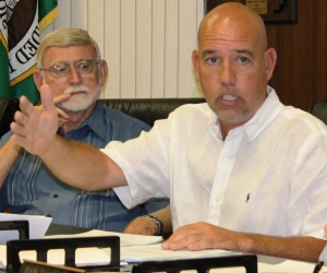 Steve Johnson, the village board's liaison to the water department, makes a point as fellow trustee Larry Johnston looks on. File photo. Photo credit: Dennis Sullivan